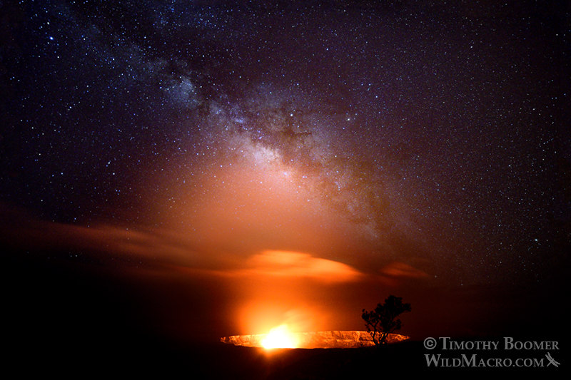 The Kīlauea Caldera glows under the Milky Way galaxy at night.  Hawai'i Volcanoes National Park, Hawaii, USA.  Stock Photo ID=SCE0201